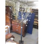A large modern ornamental light in the form of a tree, 78"h
