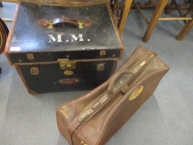A Victorian black canvas and brown leather trunk, along with a brown leather Gladstone bag