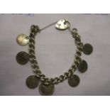 A Victorian silver chain bracelet with various silver coins and a silver locket clasp