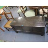 An 18th century oak chest with a hinged top and panels, on extended style feet and a 19th century