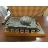 A scratch built painted model tank on an oak plinth