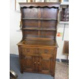 A reproduction oak dresser having a plate rack above two drawers and two cupboard doors, 71 1/4"h