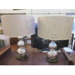 A pair of modern chrome bulbous table lamps with lilac shades