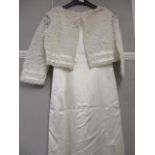 A 1970's Nettie Vogues of London, cream satin, sleeveless wedding dress with a cream satin and