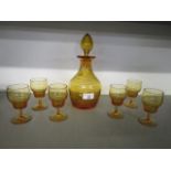 An Art Deco crystal decanter set, designed in the Statford Rings pattern in amber glass,