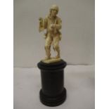 A late 19th century Dieppe carved ivory figure of man wearing tattered clothes, with his arm in a