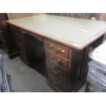A late Victorian mahogany, twin pedestal desk having a green leather top, central drawer, flanked by