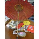 A Japanese parasol with an amber effect handle, silver plated dressing table items, theatre