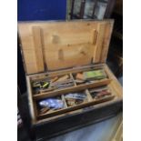 A pine tool chest containing a large selection of tools to include wood working planes, drill