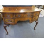 A 1920s Queen Anne style walnut bow fronted dressing table