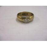 An 9ct gold band with central diamond