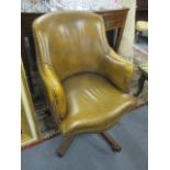 A reproduction leather upholstered, button back, swivel desk chair