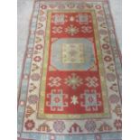 A Turkish rug geometric motifs in pastel colours