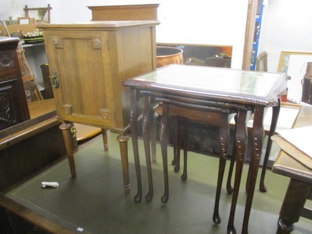 An early 20th century French style pot cupboard, together with a nest of three reproduction tables