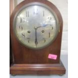 An Edwardian mahogany mantle clock with silvered dial, Arabic numerals, twin winding holes,