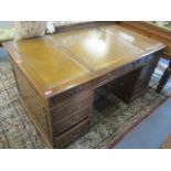 A reproduction mahogany, twin pedestal desk having a leather topped scriber, nine drawers and two