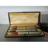 A set of four silver engine turned bridge pencils, boxed