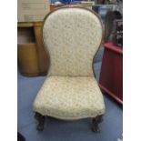 A Victorian walnut spoon back nursing chair on cabriole legs