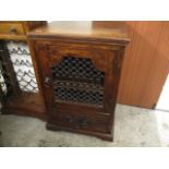 A modern teak and iron cabinet, with a lattice door and a drawer, 35" h x 24"w