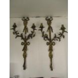 A pair of early 20th century gilt brass, twin branch appliques wit ribbon bows, entwined flowers and
