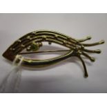 A 9ct gold and tourmaline brooch in the form of a fish, total weight, 5.64g