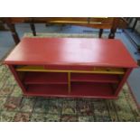 A contemporary painted pine side cabinet with open shelving and single central drawer, on bun shaped