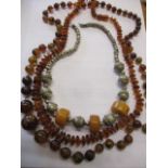 Two amber necklaces and a white metal necklace with three amber disc beads
