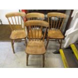 Four early 20th century elm and beech spindle back chairs
