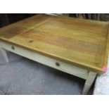 A modern tray topped, square shaped coffee table, painted cream with internal drawers and an oak