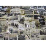 A collection of military photographs and others, contained within a vintage Bluebird tin box