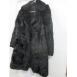 A vintage rabbit fur coat dyed black, knee length, approximately UK ladies size 12-14, together with