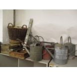 A mixed lot to include vintage wooden bottle holders, a wicker basket and galvanized watering cans