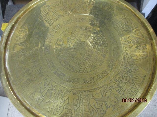 An brass tray topped table on a folding wooden stand, the tray depicting Egyptian scenes - Image 2 of 2