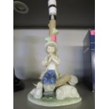 A Nao porcelain figural table lamp of a shepherd boy playing a pipe