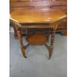 An early 20th century mahogany, octagonal, two tier occasional table, the lower tier having a