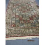 A Persian design cotton rug with panels of flowers and animals, 85" x 130" approx.