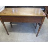 An early 20th century oak side table with a hinged top
