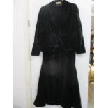 A vintage Harvey Nichols black velvet dress with matching jacket