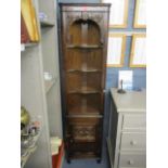 A reproduction oak corner cabinet having fitted shelves above a single cupboard door, 69" h x 17 1/