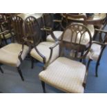 Six 1920s mahogany slat back carver dining chairs on tapered, fluted legs