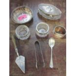 A silver trinket dish, a pair of silver rimmed salts, a silver topped glass dressing table pot and
