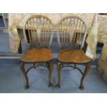 A pair of 20th century Windsor elm and beech dining chairs, with pieced centre splat, cabriole front