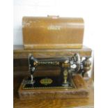 A 1920's Singer sewing machine in oak case, serial no Y1460538
