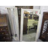 A vintage white Lloyd Loom armchair, a white painted wall mirror, a white painted vintage hanging