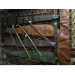 A group of leather and cloth gun slip cases, a Perazzi wooden gun stock, a gun cleaning kit and four