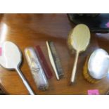 Two silver backed brushes and a silver backed and enamelled dressing table set, together with a
