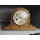 An early 20th century oak eight day mantle clock