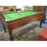 A Bar Billiards Ltd table with four cues and balls