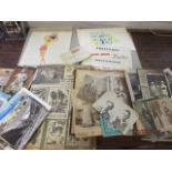 A quantity of early to late 20th century postcards and photographs, together with two scrap books