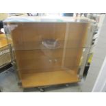 A modern retail style display cabinet with glass doors and part sides with a wood-effect back 51 1/